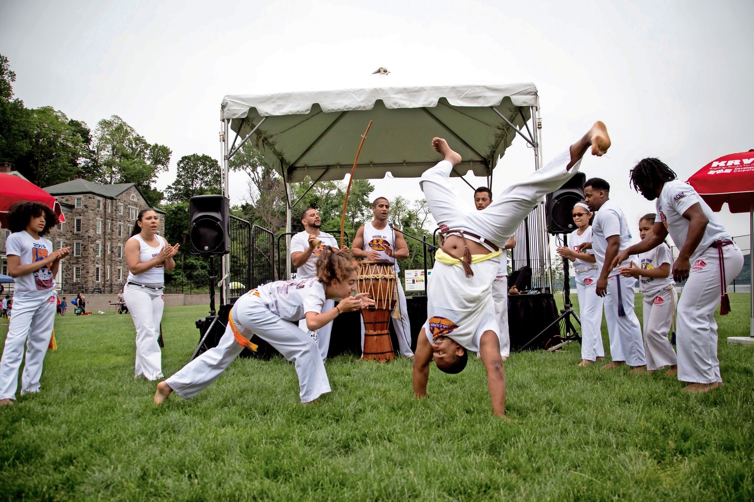 The Abada-Capoeira Bronx Cultural Arts Center performs capoeira, a Brazilian martial art that combines elements of dance, acrobatics, and self-defense techniques, during RiverFestBX.