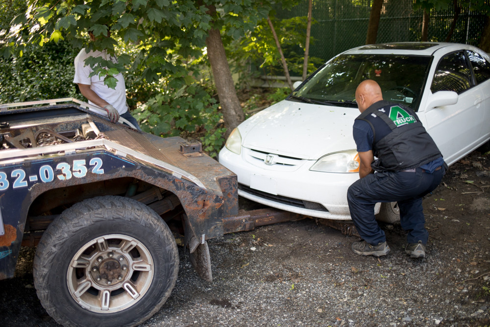 A tow truck operator secures an abandoned car to the back of the truck on West 247th Street between Henry Hudson Parkway West and Independence Avenue. It’s an area where Marlene Minarik has noticed an increasing number of abandoned vehicles. ‘This is an issue all over Riverdale,’ said Sgt. Mark Giordano of the 50th Precinct. ‘It is a major concern for the community.’