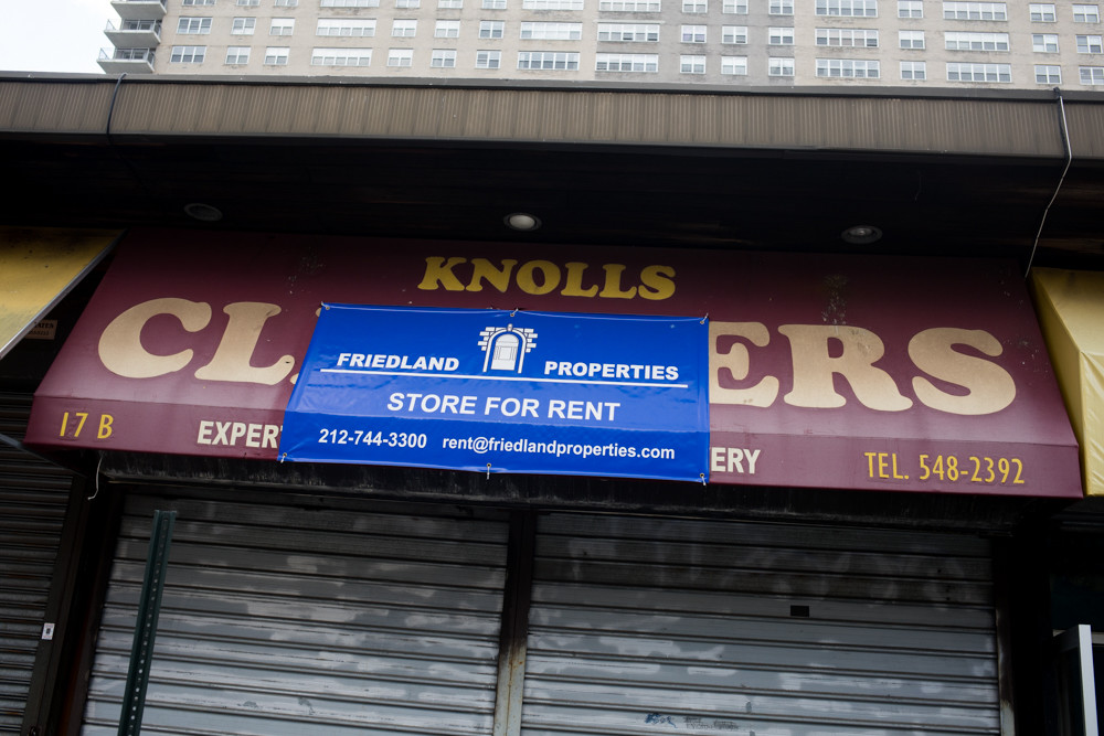 A sign for billionaire Lawrence Friedland’s company Friendland Properties partially covers the awning of the long-defunct Knolls Cleaners in Spuyten Duyvil. Along the same sleepy strip, Kappock Cafe and Wine Bar, also in a Friedland-owned storefront, is the latest to shutter, to the dismay of neighboring business owners.