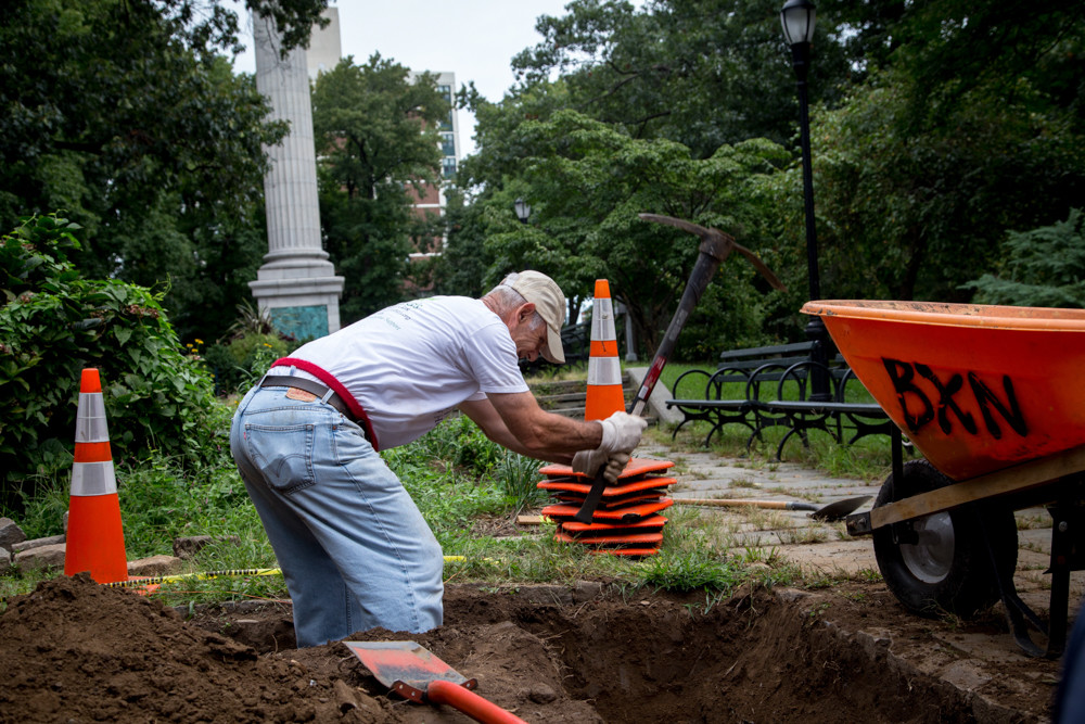 Mark Mason, a co-founder of the Stewards of Henry Hudson Park, works to clear a plant bed.