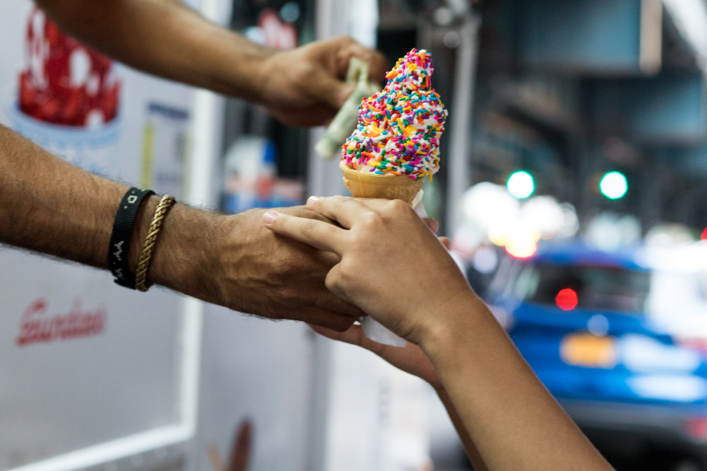 A Mister Softee truck driver calling himself Victor Emmanuel hands a vanilla cone with rainbow sprinkles to a customer on the corner of West 231st Street and Broadway. While Kingsbridge is among the city’s top neighborhoods for ice cream truck jingle-related noise complaints, several customers who stopped by Emmanuel’s truck Sept. 14 say the tune never really bothered them.