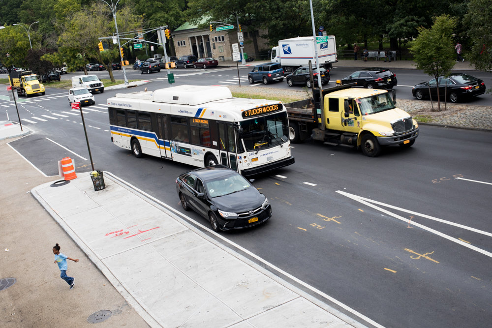 A Bee-Line bus from Westchester County navigates around a stopped car at a bus bulb located on the southbound side of Broadway near West 242nd Street. Nearby merchants have complained about the traffic problems this newly installed bulb causes.