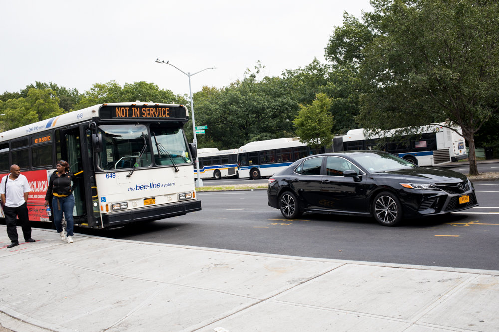 A car loops in front of a Westchester County Bee-Line bus dropping off passengers at a bus bulb located on the southbound side of Broadway near West 242nd Street. The bulb not only has created some problems with traffic, according to some local business owners, but it’s also pulled away much-needed parking.