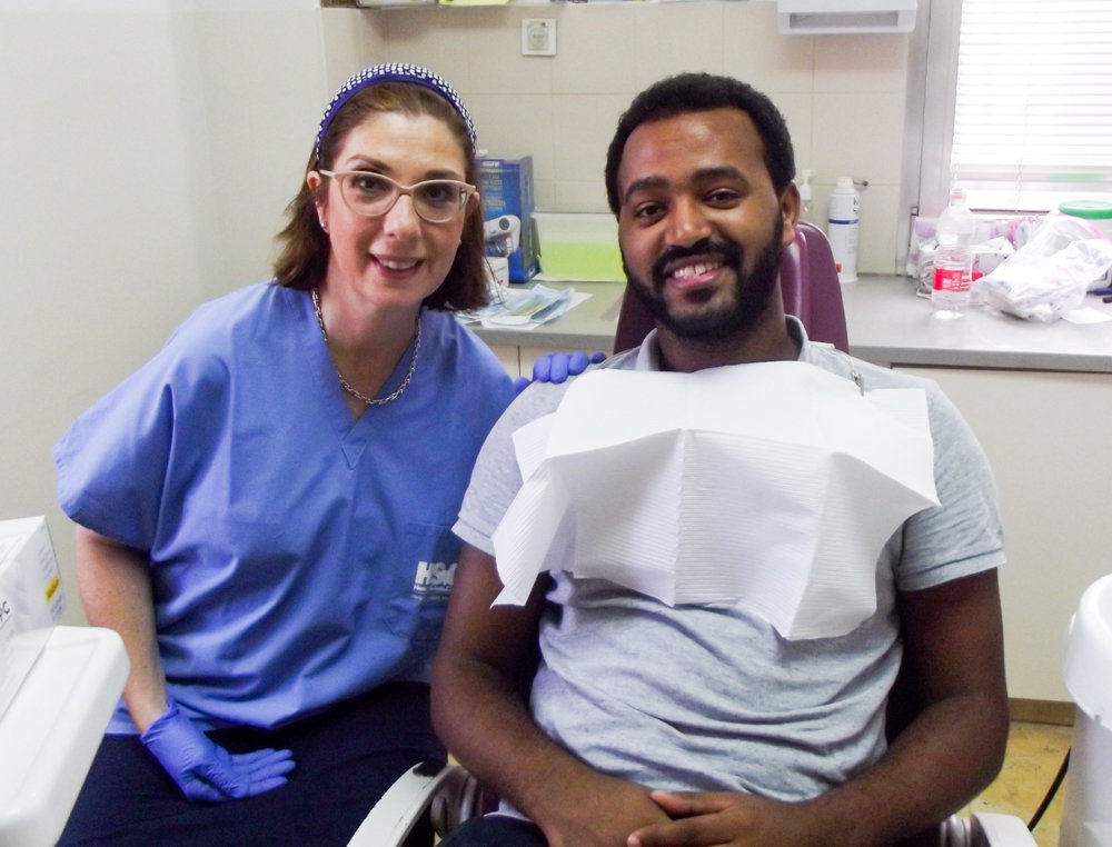 Dentist Sandra Molinas smiles with a patient at a clinic in Jerusalem. Molinas recently traveled to Israel as part of the Dental Volunteers for Israel program, which provides free dental care to those who need it, and which Molinas has been a volunteer for more than five years.