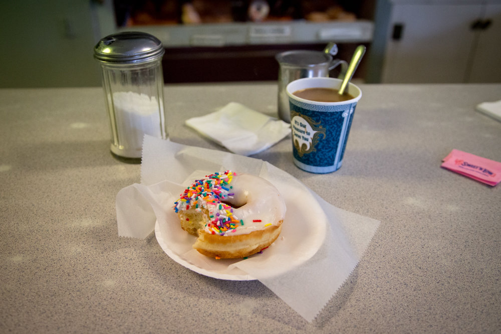 Since his return to Riverdale and the surrounding neighborhoods as a photojournalist, Eian Kantor finds the Kingsbridge Donut Shop to be one of his new favorite places. ‘Every time I’ve gone in, I’ve sat at the counter and had a conversation for over an hour with a stranger,’ he says.