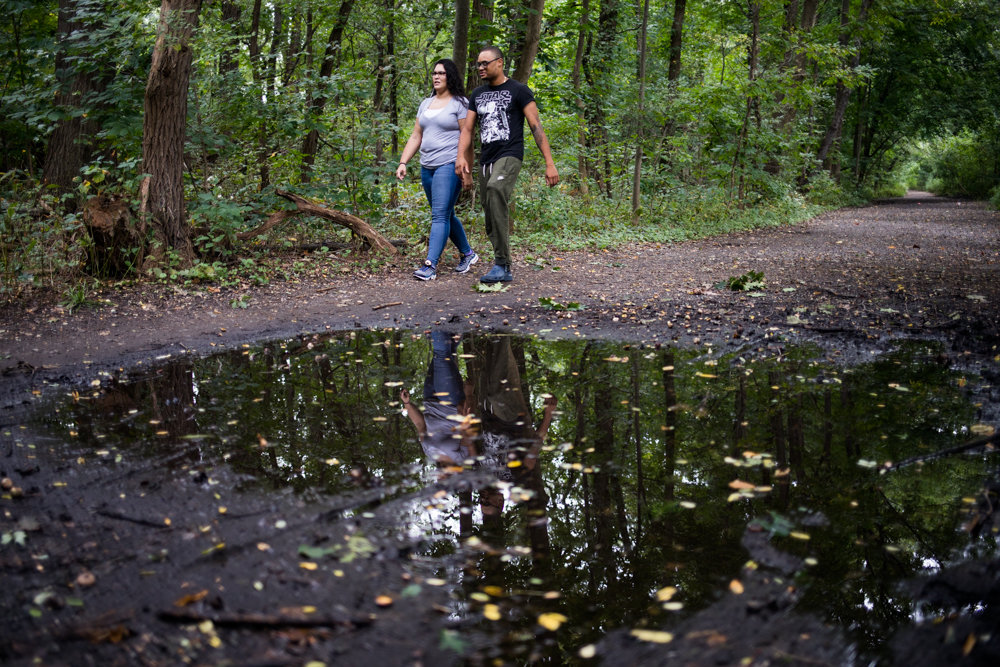 Toni Seguinot and Adam Woodley walk alongside a puddle on the Old Putnam Trail in Van Cortlandt Park. A plan is in place — and funding secured — to pave a portion of the trail extending from the northern region of the park to the bottom of Van Cortlandt Lake. But both Seguinot and Woodley, who walk the trail at least once a week, feel it would diminish the park’s natural beauty.