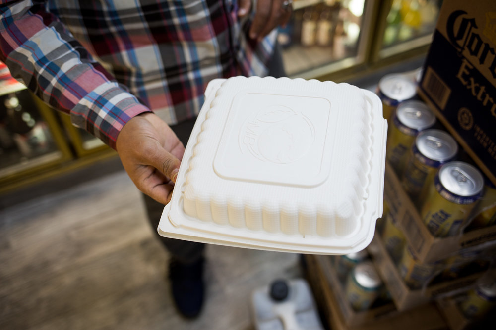 Jay Aowas, owner of Jasper’s Deli on West 238th Street, holds out a plastic food container. Aowas made the switch from plastic foam to a different kind of plastic some six months ago, ahead of the city’s foam ban Jan. 1. He figured the fines weren’t worth it, and wanted to get a head start transitioning to alternative food packaging, including the plastic-based containers he uses now. While they cost a bit more, Aowas believes eliminating foam is better for the environment.