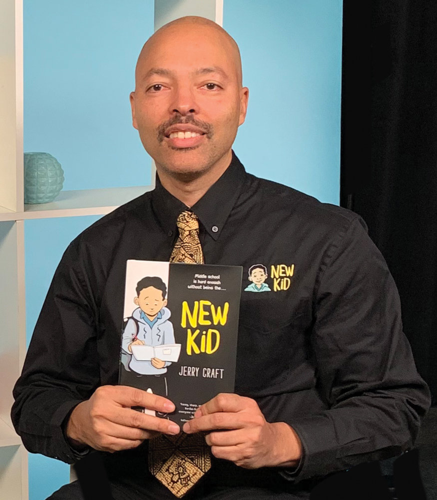 Jerry Craft smiles with a copy of his soon-to-be-published graphic novel, ‘New Kid,’ which details the story of an African-American student finding himself as the new kid at an affluent, mostly white school. It’s based on Craft’s experience as a student at Ethical Culture Fieldston School.