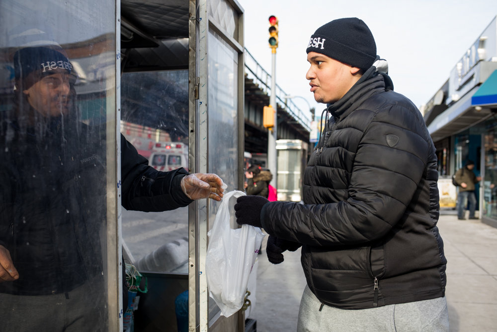 Jeremy Serrano picks up his order from Rachid Tahzima, who runs the Halal Brother food cart on Broadway just south of West 231st Street. Tahzima — who says he already diligently cleans his mobile food establishment — believes it’s a good idea food carts receive letter grades from the city’s health department so customers can know the quality of service and cleanliness they’re getting. Health inspectors started grading mobile vendors in January.