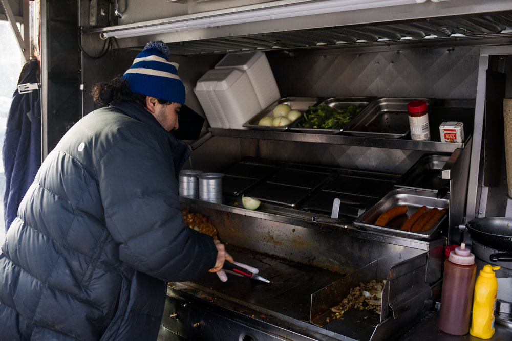 Rachid Tahzima cleans the grill in his food cart, Halal Brother, on Broadway just south of West 231st Street below the elevated 1 train tracks. A well-loved purveyor of gyros, hot dogs and more, Tahzima is in favor of the city health department’s effort to assign letter grades to food carts based on criteria like freshness of ingredients and how clean and organized the space and equipment are maintained.
