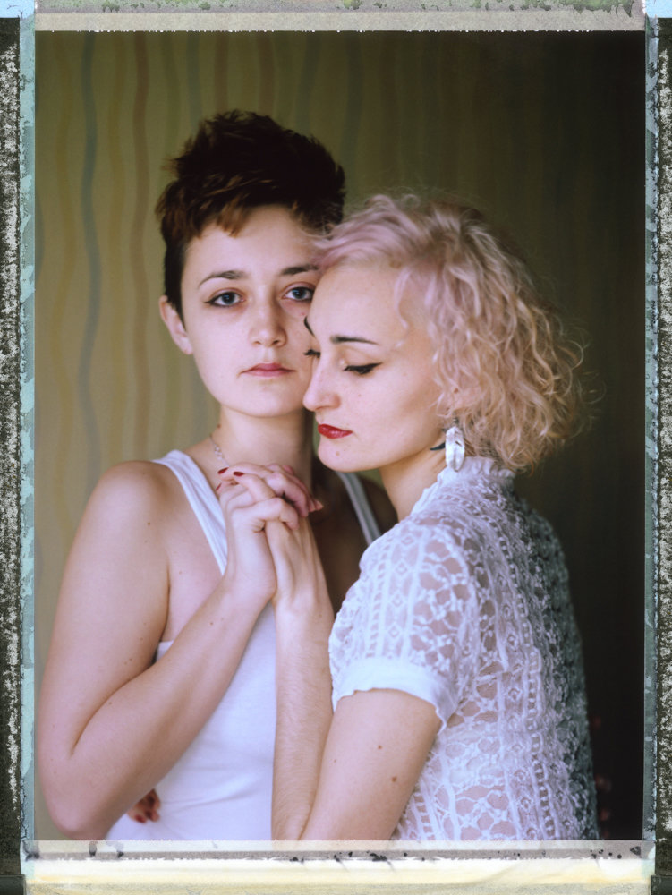 ‘D’ and ‘O,’ right, a lesbian couple, pose for a portrait in Russia in 2014. Photographer Robin Hammond took their picture for his series ‘Where Love is Illegal,’ featuring portraits of members of the LGBTQ community in countries where there are laws criminalizing their sexual activity. An exhibition of the work is on display at the Bronx Documentary Center through March 24.