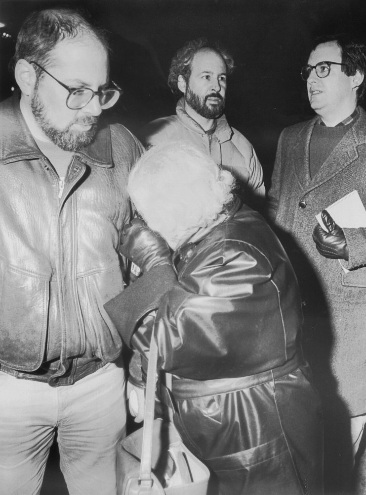 Celia Stein, at right, breaks down in tears on son Richie Stein’s arm, while Press deputy editor Tom Watson, right, confers with editor Buddy Stein.