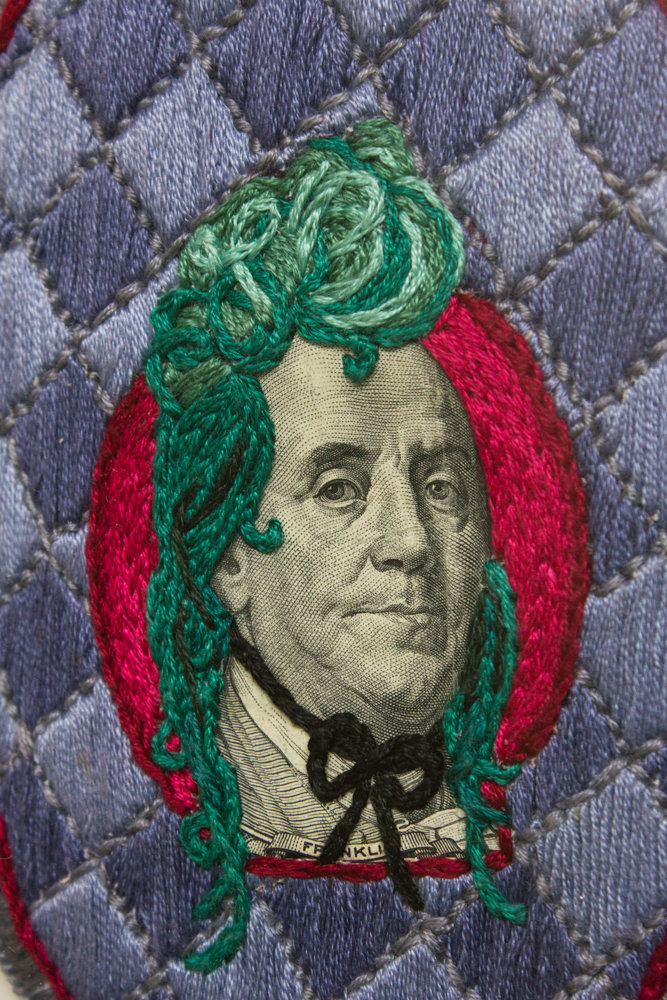 Stacey Lee Webber used real money like this $100 bill to embroider on for her series, ‘The Costume Party.’ Her work is on display at the Lehman College Art Gallery through May 4.