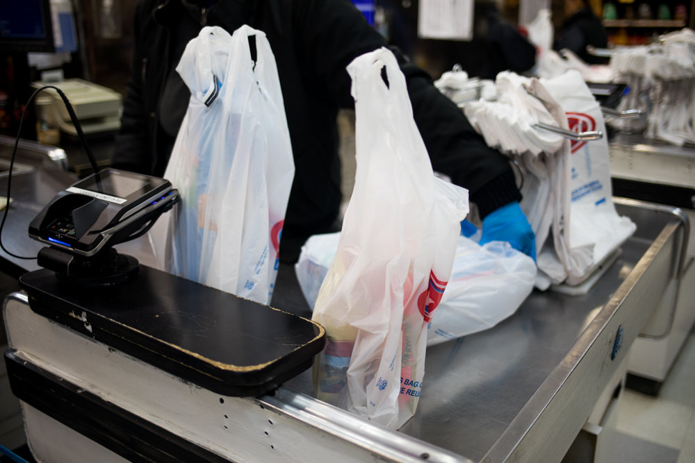Groceries in plastic bags sit on the checkout counter in Key Food on Riverdale Avenue. New York has become the second state to ban single-use plastic bags after California did so in 2016. The plan, which is expected to go into effect next March, will give counties the option to impose a 5-cent fee on paper bags.