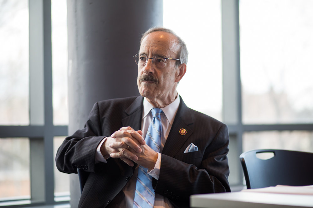 U.S. Rep. Eliot Engel listens as he is introduced by Manhattan College students. Engel visited the school to talk about this migration crisis and his recent trips to the U.S.-Mexico border and several countries in Central America.