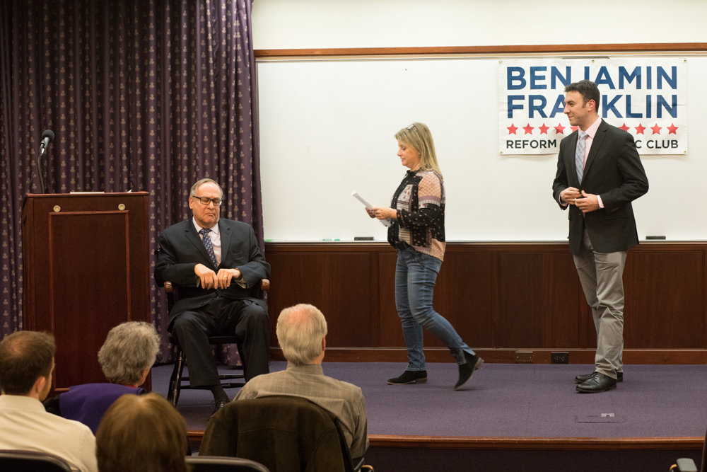 Eric Dinowitz, right, stands on stage at a forum the Ben Franklin Club organized at Manhattan College for public advocate candidates last year. Dinowitz entered the race early for city council, but stumbled when he erroneously claimed on his campaign website that the United Federation of Teachers endorsed him.