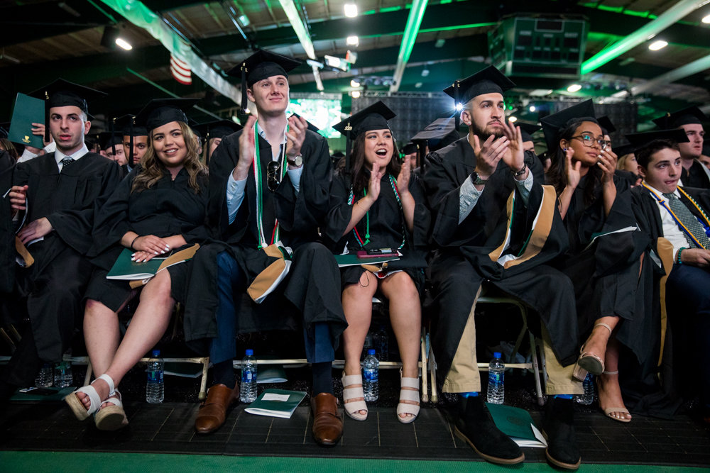 Graduating seniors at Manhattan College applaud the conclusion of Donya Quhshi’s valedictory speech.