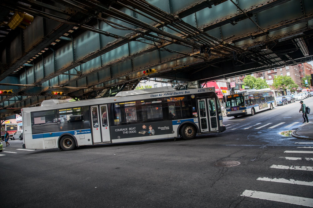 A Bx7 crosses onto West 231st Street from Broadway while a Norwood-bound Bx10 waits to cross. The Bronx has a beleaguered bus system, and transit advocacy groups are clamoring for a host of reforms to improve service.
