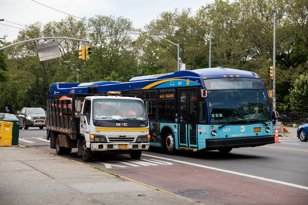 A Bx12 bus navigates around a truck idling in the bus lane on West Fordham Road. The city’s transportation department wants to install bus lanes like this on Broadway between West 225th and West 230th streets in Marble Hill.