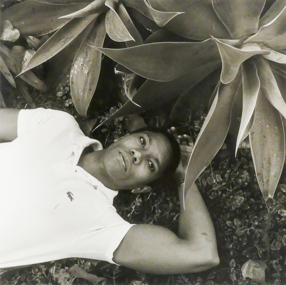 Novelist Larry Duplechan lies on the ground in Santa Monica, California, in a 1988 portrait by Robert Giard. This photograph is included in the exhibition ‘Particular Voices,’ on display at Daniel Cooney Fine Art through July 26.