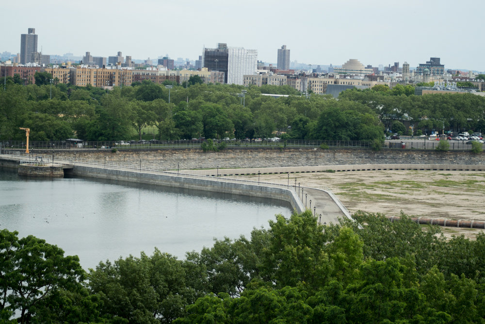 A walkway separates the north basin from the south in the Jerome Park Reservoir, long a contested battleground for residents and city officials. Repair work has left the south basin empty, but once those repairs are complete, it will be the north basin that’s empty, much to the chagrin of neighbors.