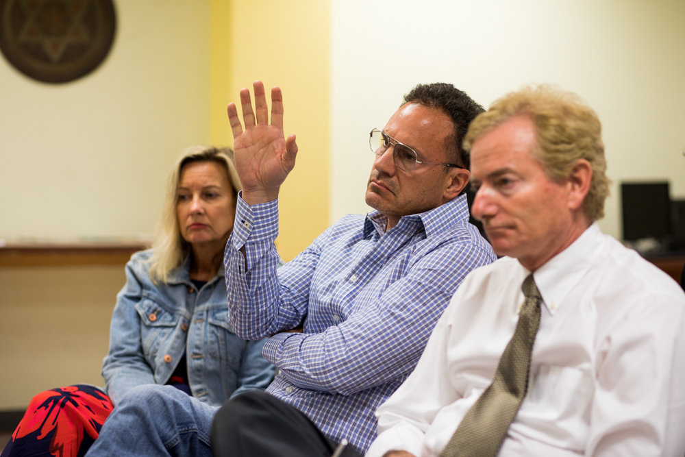 Cliff Stanton, chair of the Friends of the Hudson River Greenway, raises his hand to ask Bob Bender a question during a meeting of Community Board 8’s special greenway committee June 12.