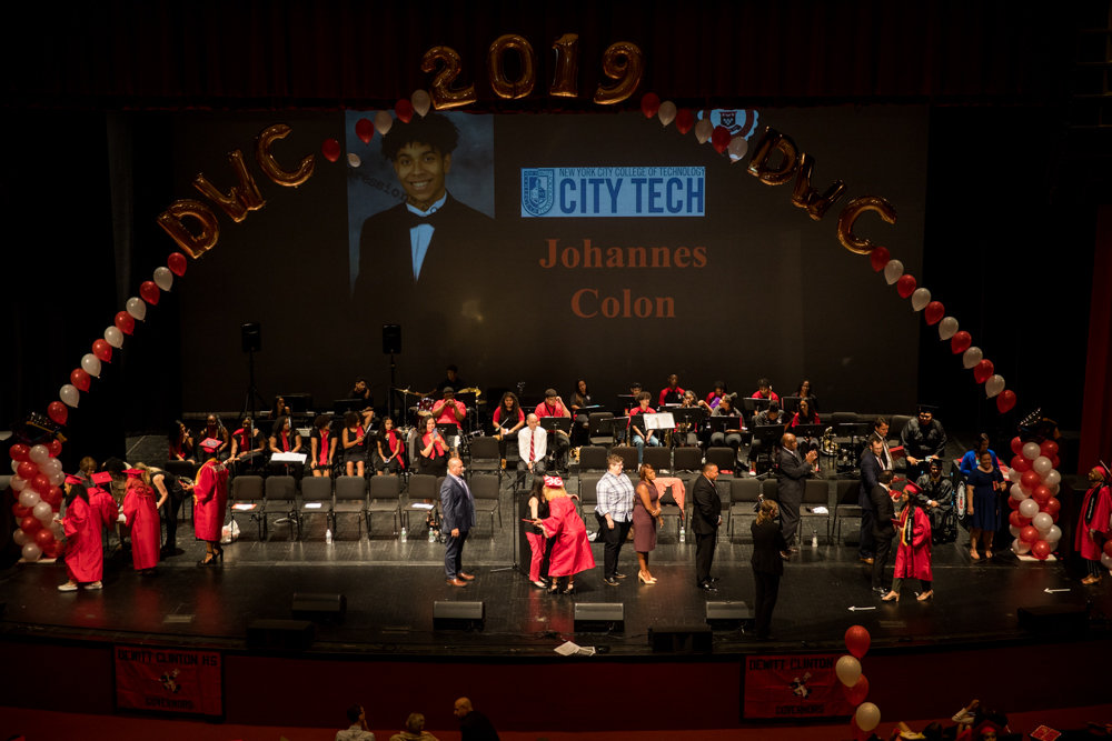 Graduating seniors from DeWitt Clinton High School walk on stage to receive their diplomas.