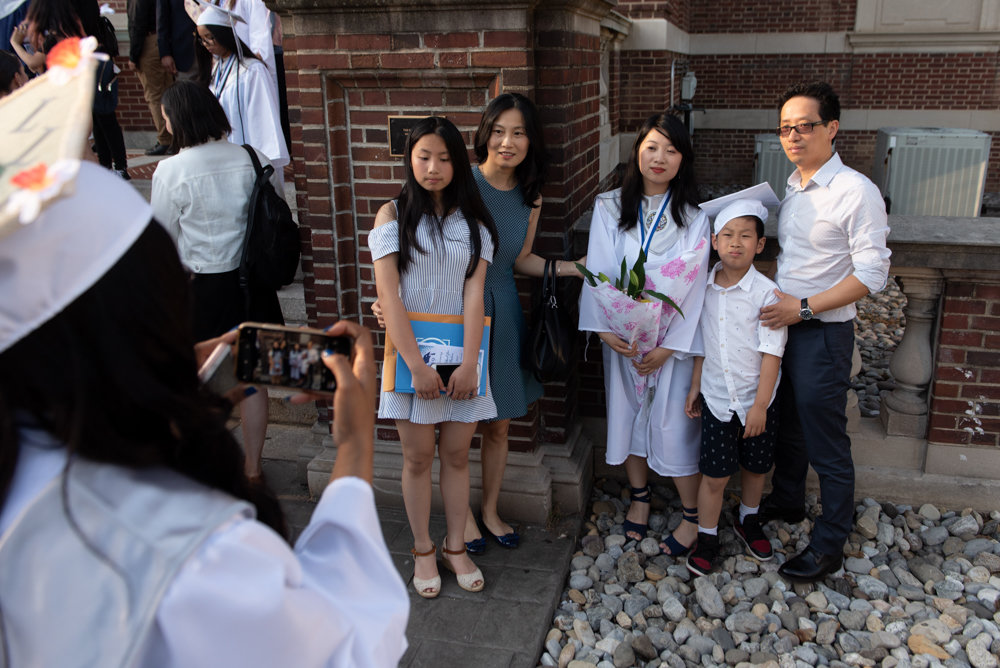 Graduates of Marble Hill School for International Studies take pictures with loved ones after their graduation ceremony at the College of Mount Saint Vincent.
