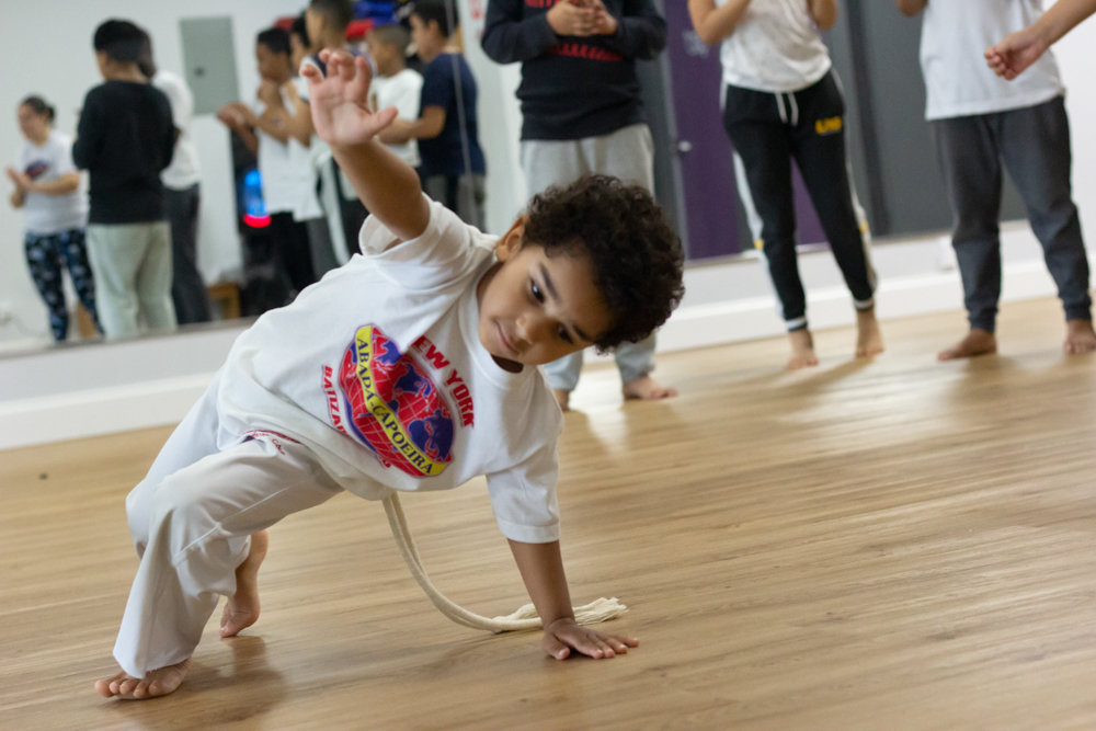 A young capoeirista trains in ABADÁ-Capoeira Bronx near the West 242nd Street subway station. Practitioners of capoeira traditionally wear white.