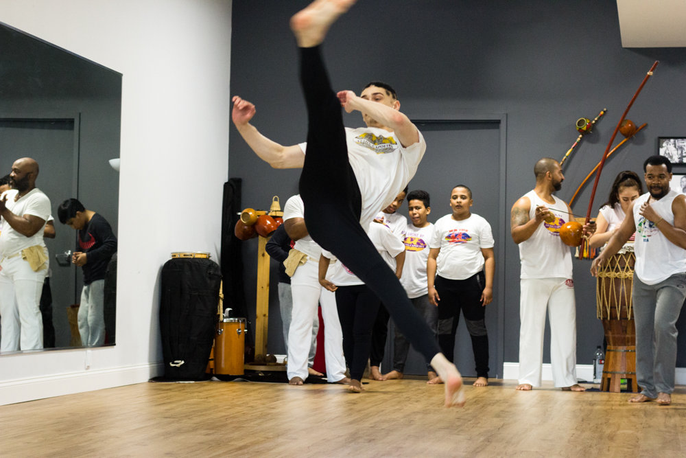 Brandon Taft executes the ‘armada com martelo,’ a jumping spinning kick and one of the most difficult moves in capoeira, at ABADÁ-Capoeira Bronx. In the studio, he goes by the nickname ‘Gasparzinho.’