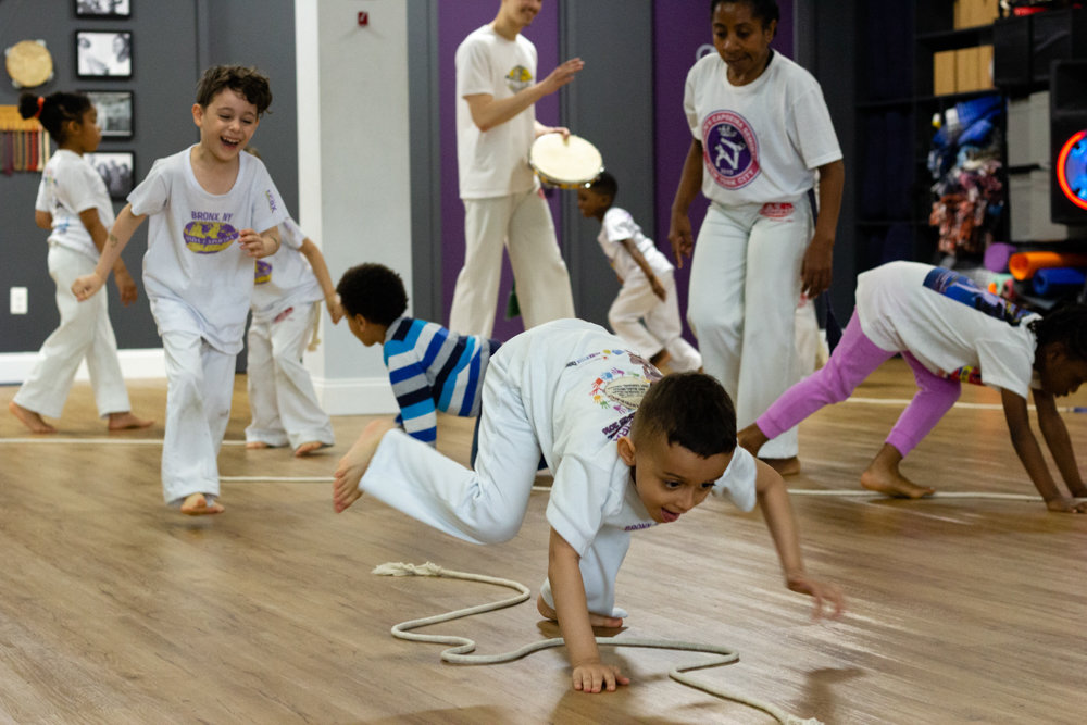 Kids practice drills during a class at ABADÁ-Capoeira Bronx.