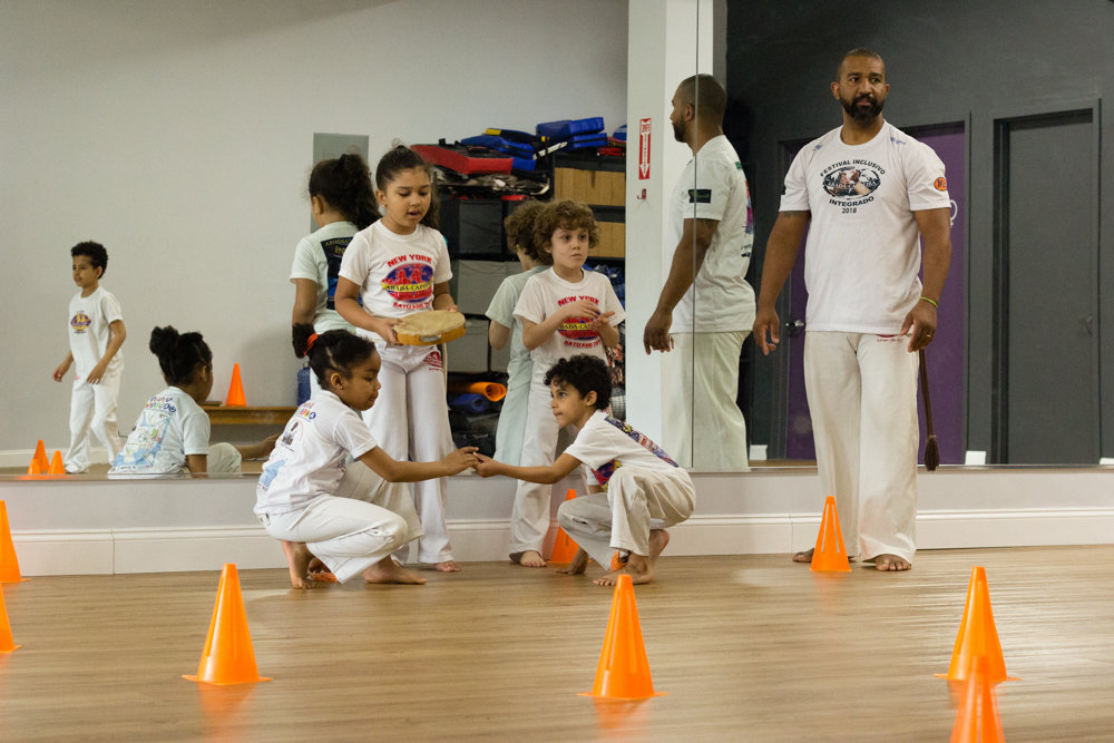 Marcelo Fagundes, right, teaches his students how to initiate a game of capoeira in his ABADÁ-Capoeira Bronx studio.
