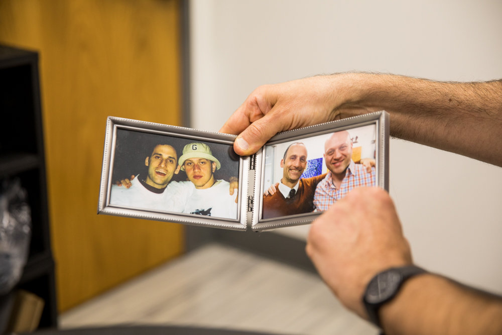 Rabbi Aaron Frank, head of school for Kinneret Day School, shows two pictures of the same Kinneret student taken decades apart. When Frank worked full-time as a rabbi at the Hebrew Institute of Riverdale, he often visited Kinneret, which he ultimately joined four years ago.
