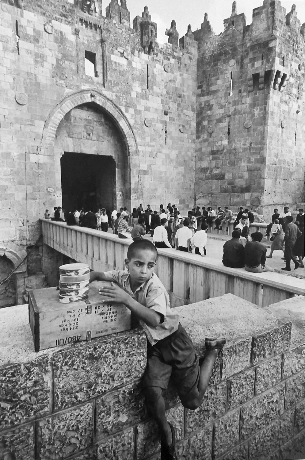 An Arab fish seller is stationed near the Damascus Gate in Jerusalem in a 1967 photograph by Leonard Freed.