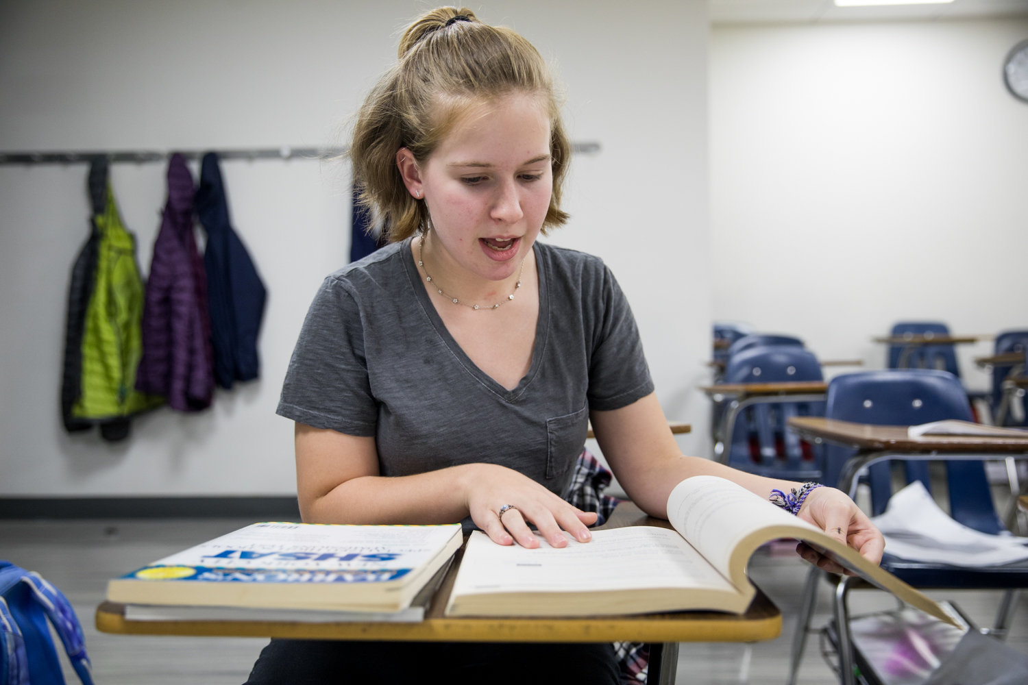 Kinneret Day School student Talia Schuldenrein looks through one of the test prep books she used to study for the Specialized High School Admissions Test, which she took along with thousands of other students Oct. 26. Talia hopes to get into Bronx Science where her father went to school.