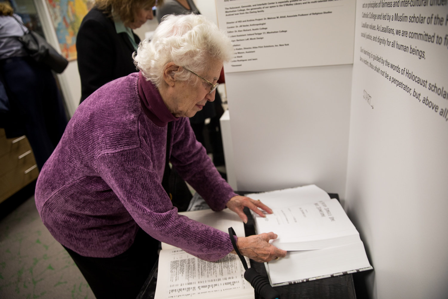 Sonja Geismar looks through a copy of ‘And Every Single One Was Someone,’ a book in which the word ‘Jew’ is repeated six million times, in the Herman and Lea Ziering Archive Collection at Manhattan College.