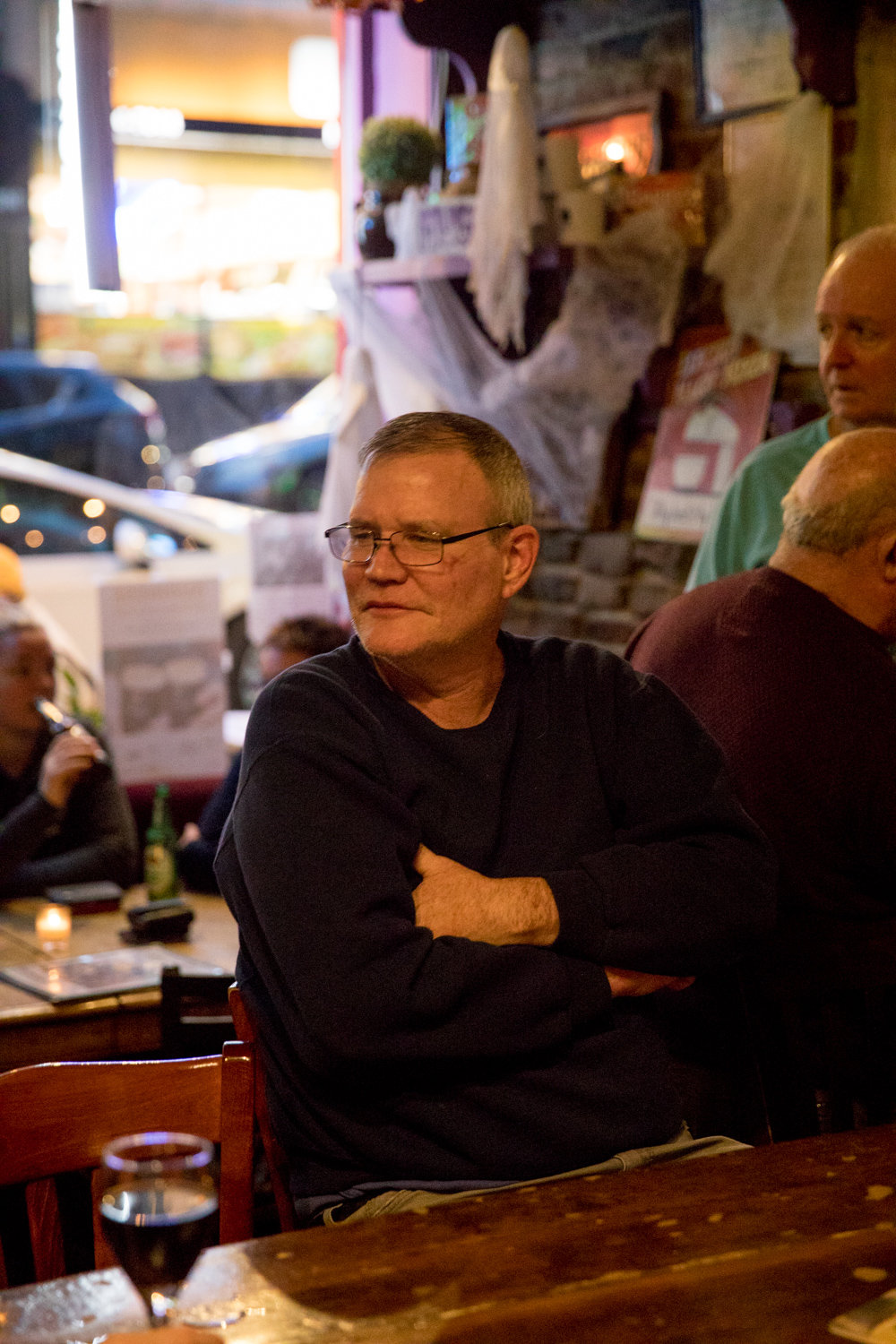 James Powers listens to Mary Courtney perform Irish music at An Beal Bocht Café on West 238th Street, where he is a regular.