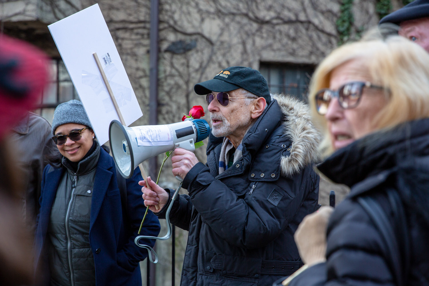 Perry Brass rallies a group of concerned neighbors in front of the sister buildings of the Villa Rosa Bonheur before leading the crowd to the threatened apartment building for a vigil in February.