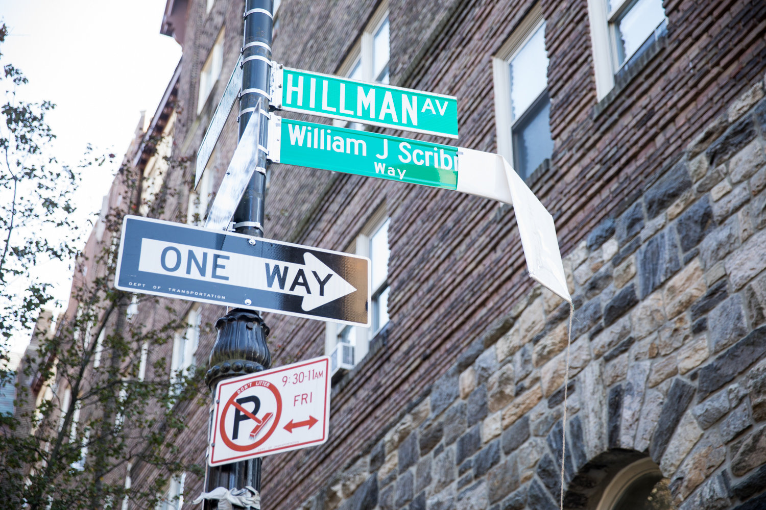 The sign for William J. Scribner Way is unveiled during a Nov. 15 ceremony. The corner of Hillman Avenue and Van Cortlandt Park South is named for the late founder of the Bronx Arts Ensemble, which is headquartered nearby.