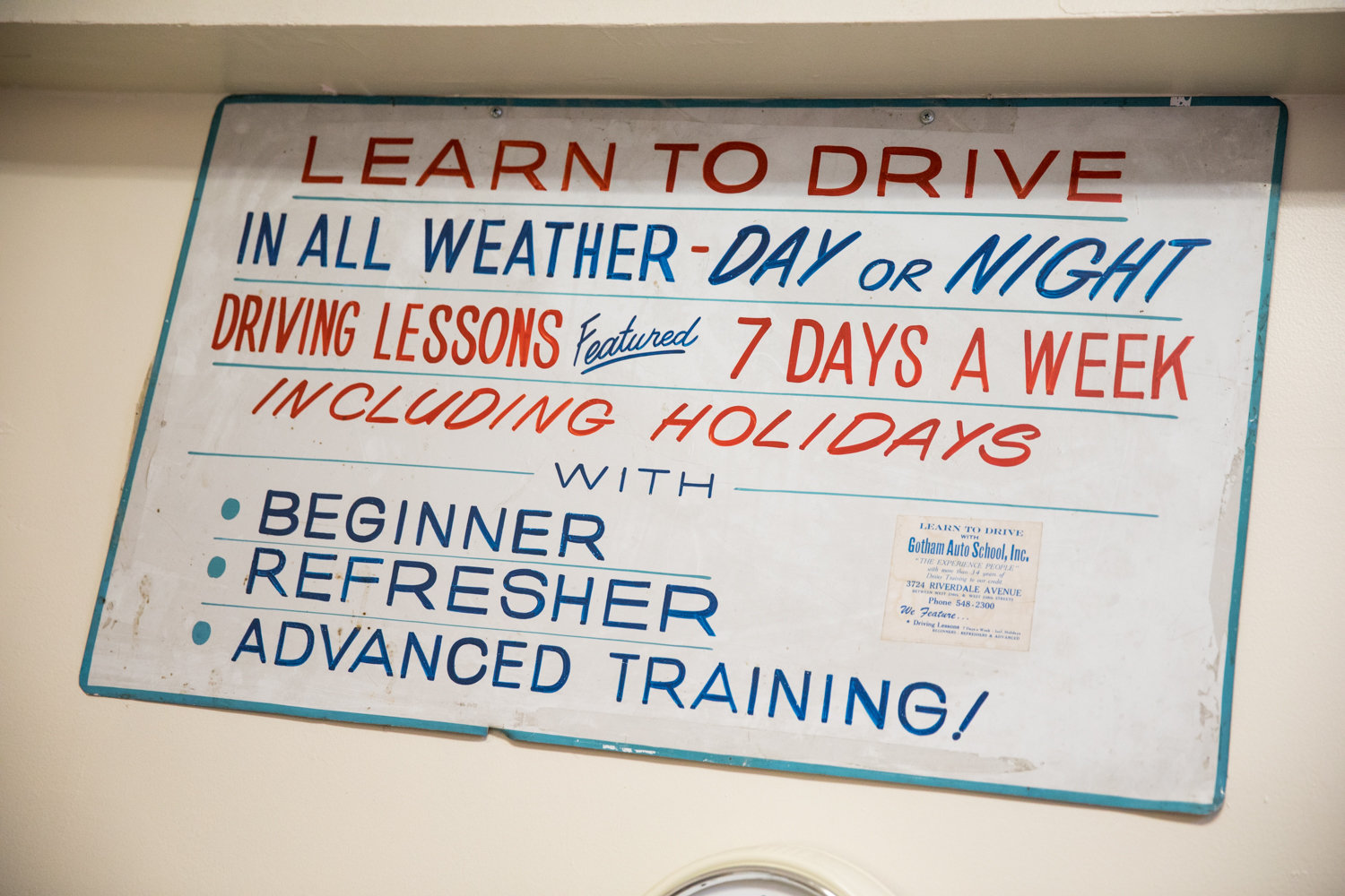 An old fashioned sign adorns a wall inside Gotham Driving School on Mosholu Avenue. Irene Goldstein, the school’s owner, isn’t concerned with the state’s new ‘green light’ law that grants undocumented immigrants the ability to get driver’s licenses. Her interest is in helping people learn how to drive, regardless of their background.