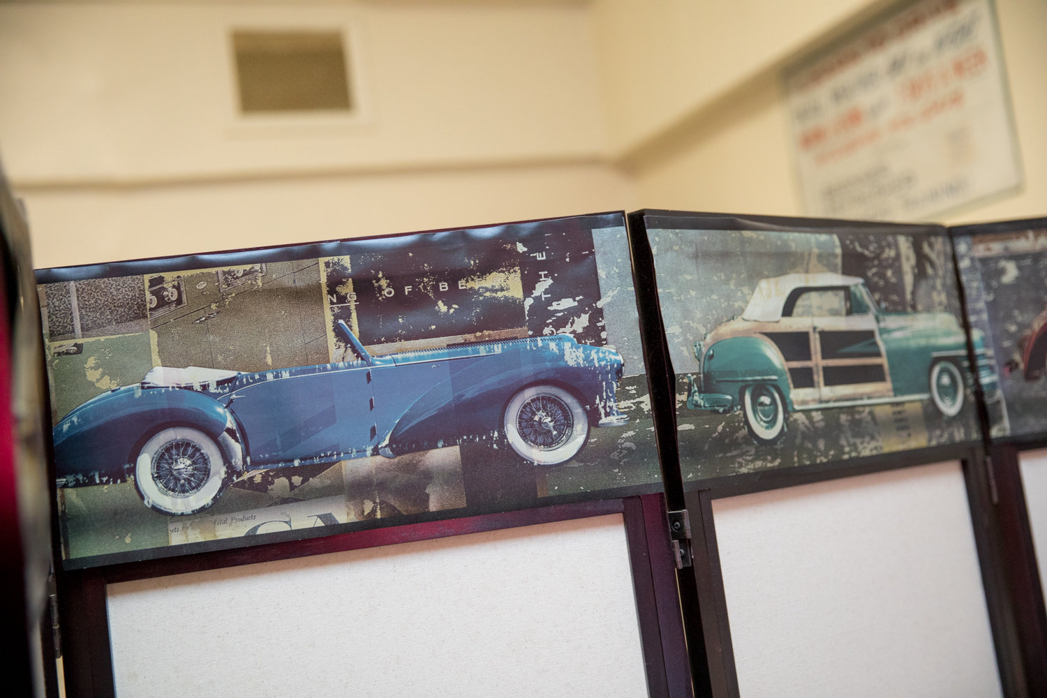 Pictures of vintage cars adorn a divider inside Gotham Driving School on Mosholu Avenue. Irene Goldstein, the school’s owner, isn’t concerned with the state’s new ‘green light’ law that grants undocumented immigrants the ability to get driver’s licenses. Her interest instead is in helping people learn how to drive, regardless of their background.