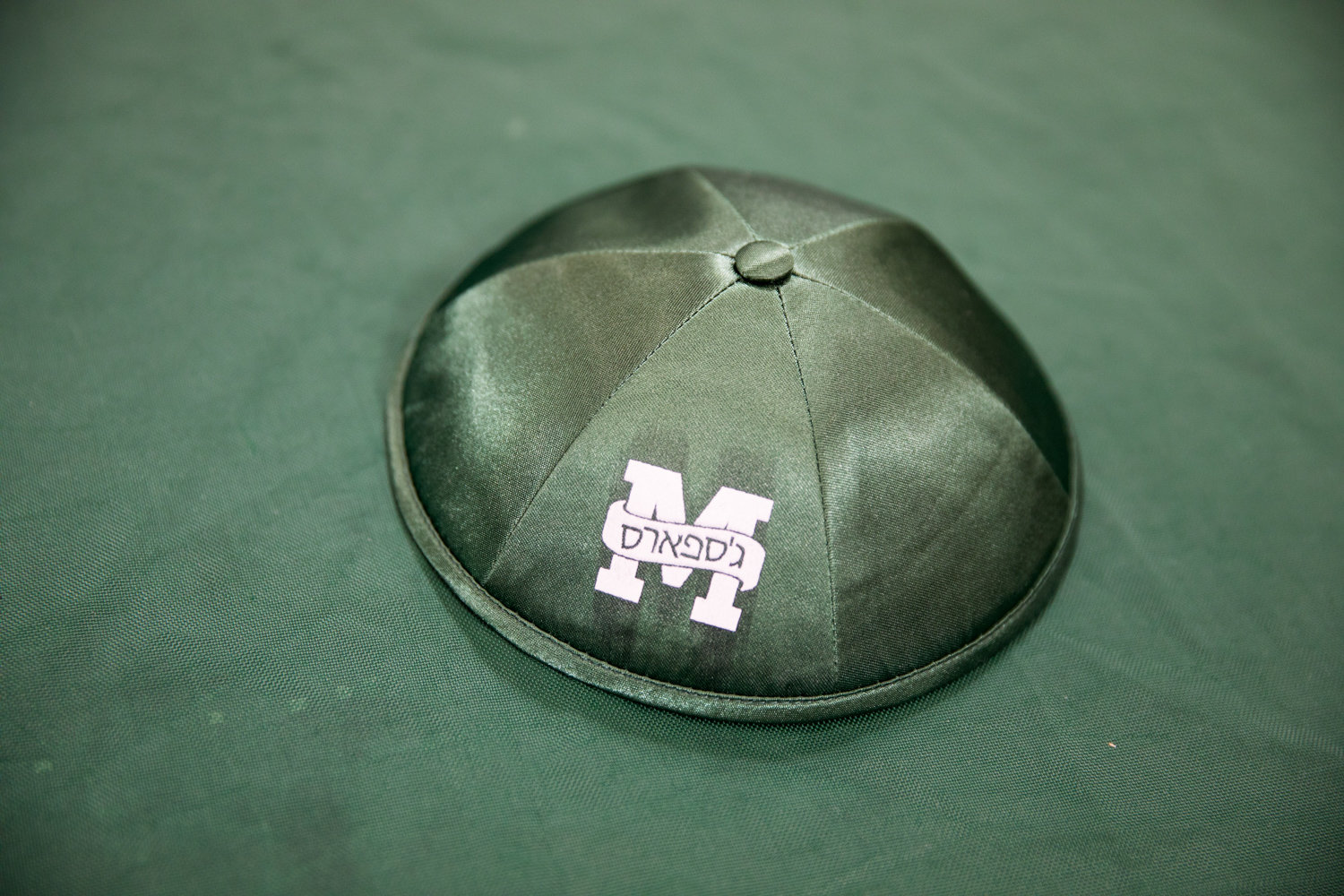 Manhattan players Daniel Schreier and Ethan Lasko own custom yarmulkes featuring the Jaspers’ logo.