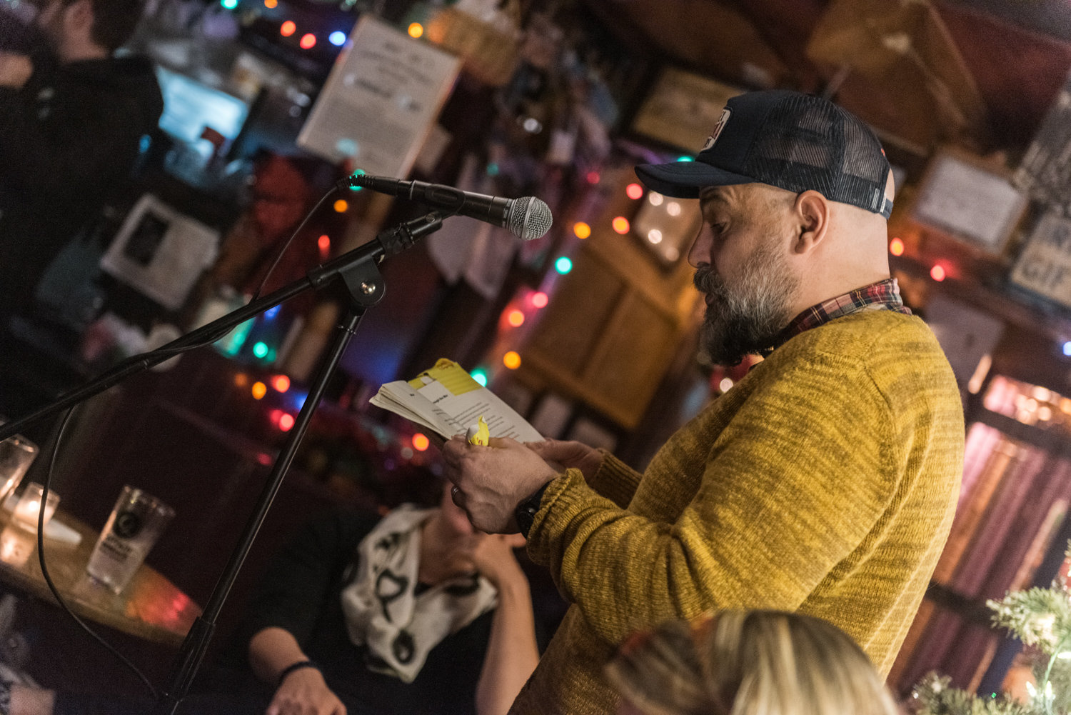 Timothy Donnelly reads a poem from his recently published book ‘The Problem of the Many’ at the 10-year anniversary of the Poor Mouth Writer’s Night at An Beal Bocht Cafe on Dec. 11.