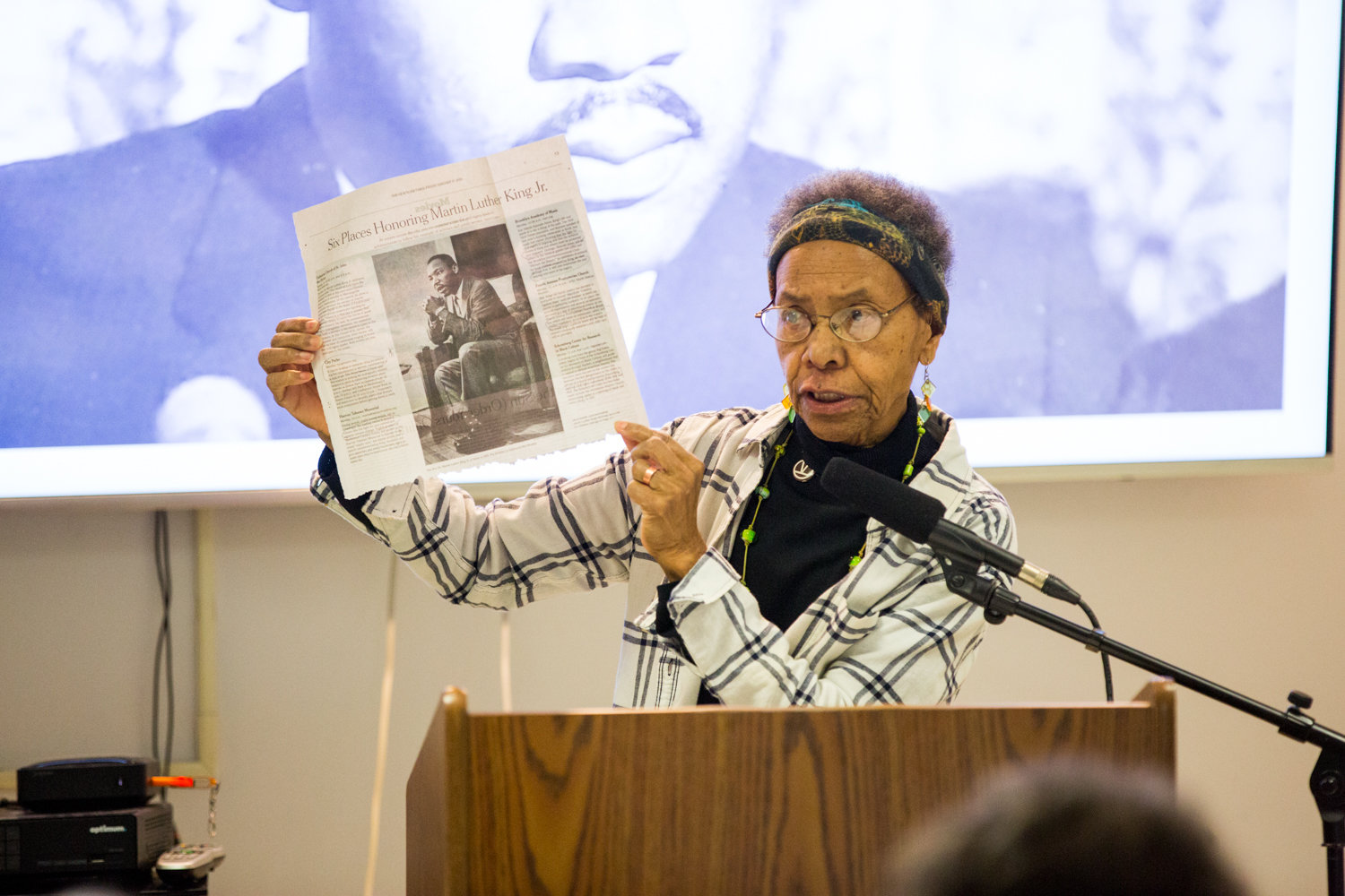 Ernece Kelly holds up a newspaper story about Dr. Martin Luther King Jr., during a presentation last week at RSS-Riverdale Senior Services. Kelly worked for King in Chicago.