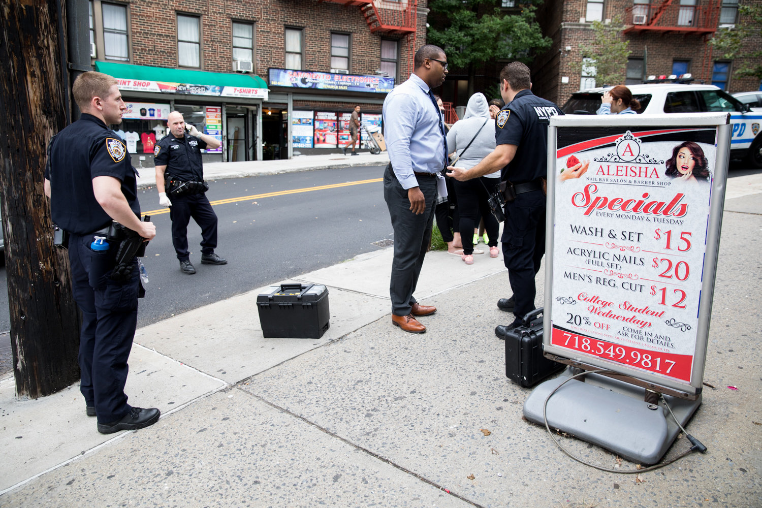 Police officers and detectives respond to a string of burglaries at three businesses on West 238th Street near Bailey Avenue last September. The 50th Precinct saw a slight uptick in crimes last year, but some of the more violent kinds of crime like murder and gun-related incidents actually fell.