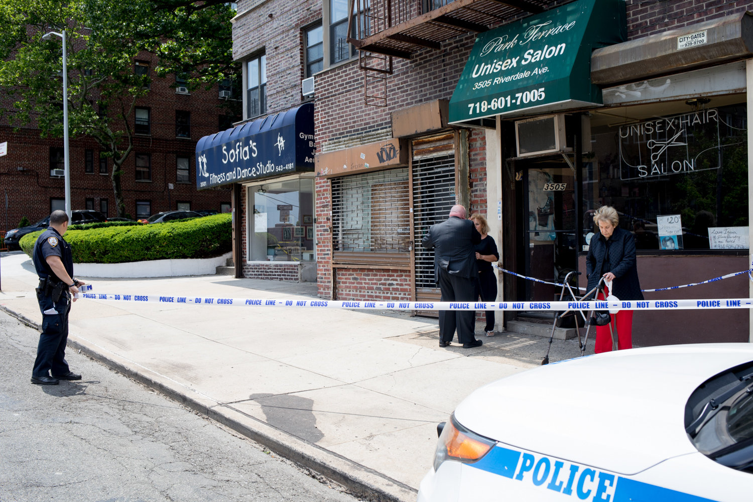 A police officer sets up a perimeter around the Park Terrace Unisex Salon on Riverdale Avenue during a robbery investigation in June 2018. Crime in the 50th Precinct climbed slightly last year compared to what ultimately became a very busy 2018.