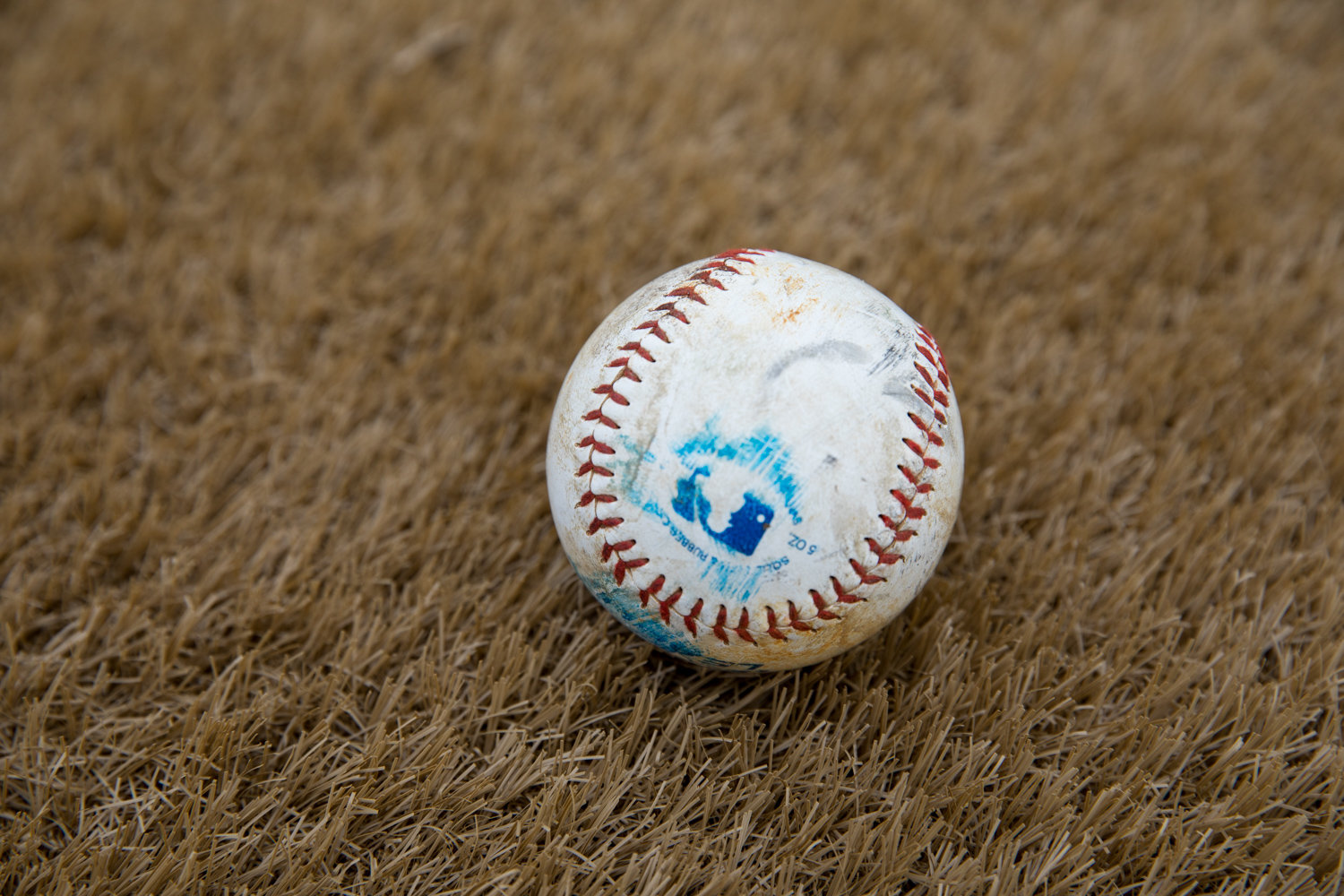A baseball rests on the artificial turf of one of the newly renovated ballfields at Seton Park. The last of the construction fencing was removed from the park Jan. 30, marking the end of the renovation work that began last year.