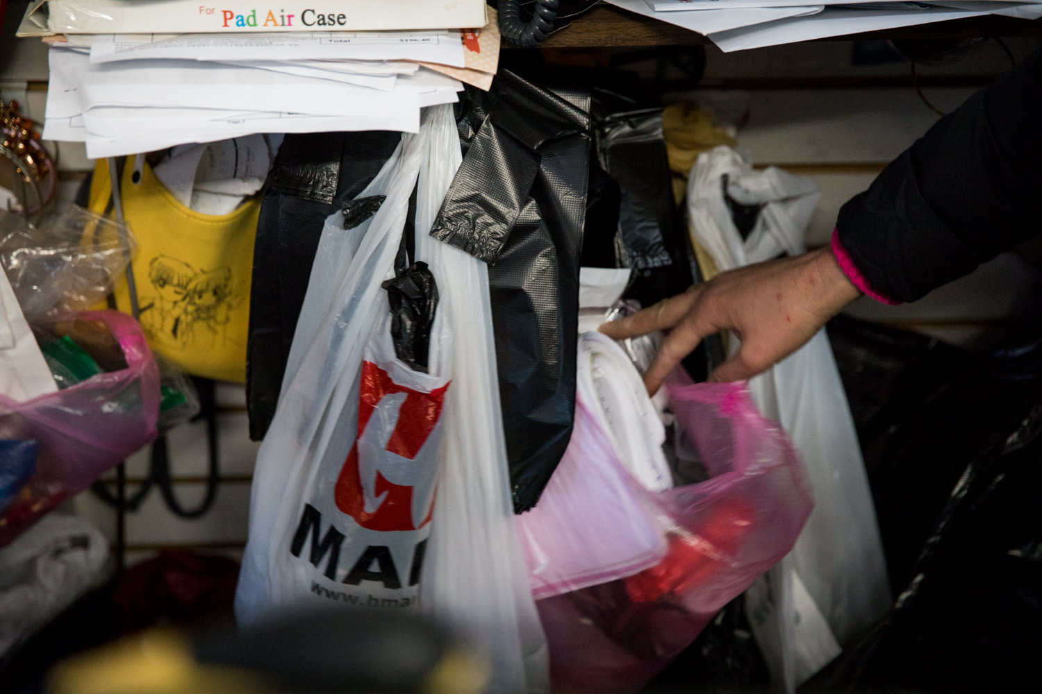 Kay Lin isn’t worried about having to make the switch to paper bags at Family Discount on Riverdale Avenue. The purchases at her store tend to be small, and some of her customers simply carry them out. Others bring their own bags.