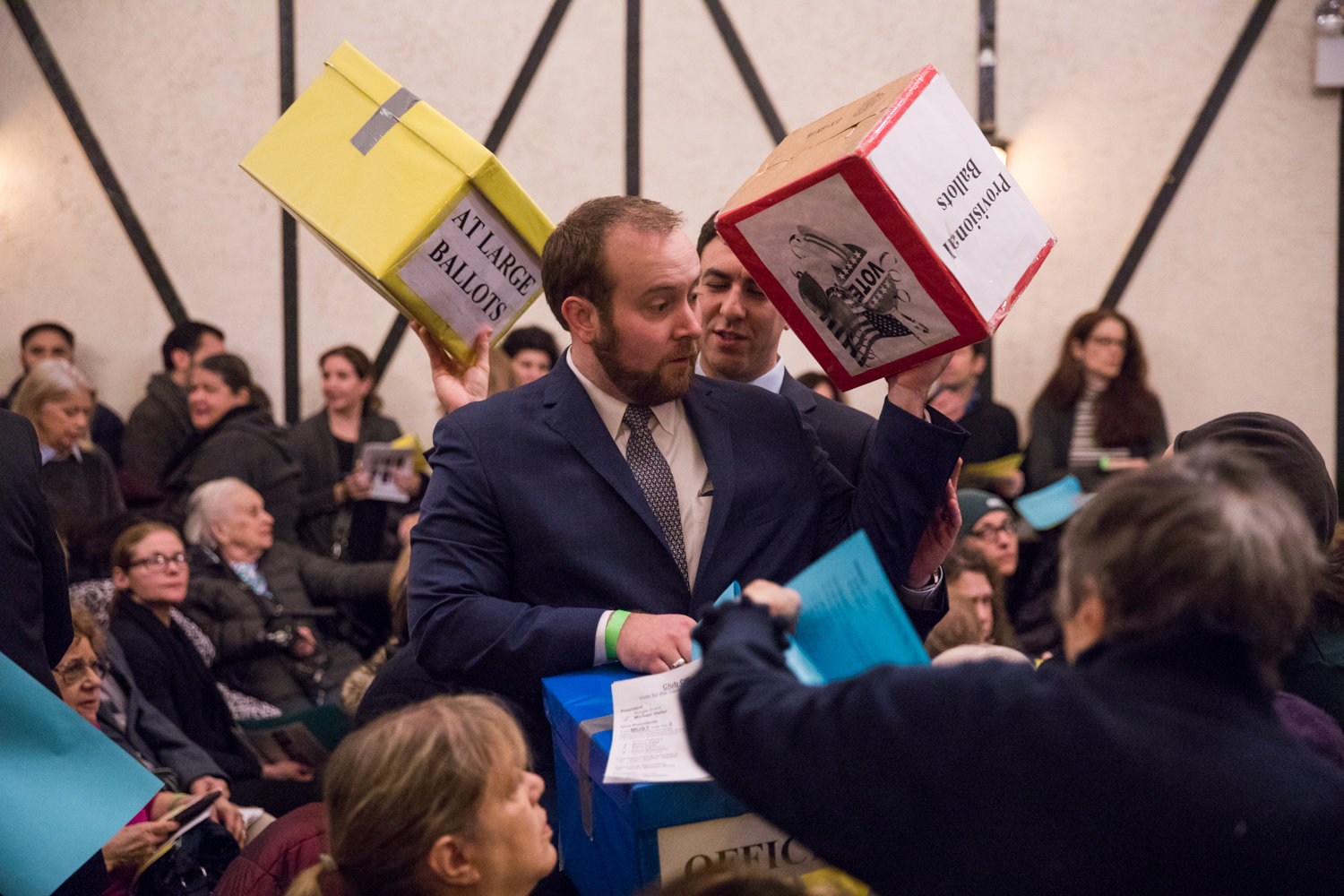 Ivan ‘Duffy’ Nedds, center left, and Eric Dinowitz carry ballot boxes during the Benjamin Franklin Reform Democratic Club’s annual meeting Jan. 29 that saw incumbents win re-election. Both have close connections to Assemblyman Jeffrey Dinowitz — Nedds is a paid staffer in the lawmaker’s district office, while Eric is his son, who also is running for city council.