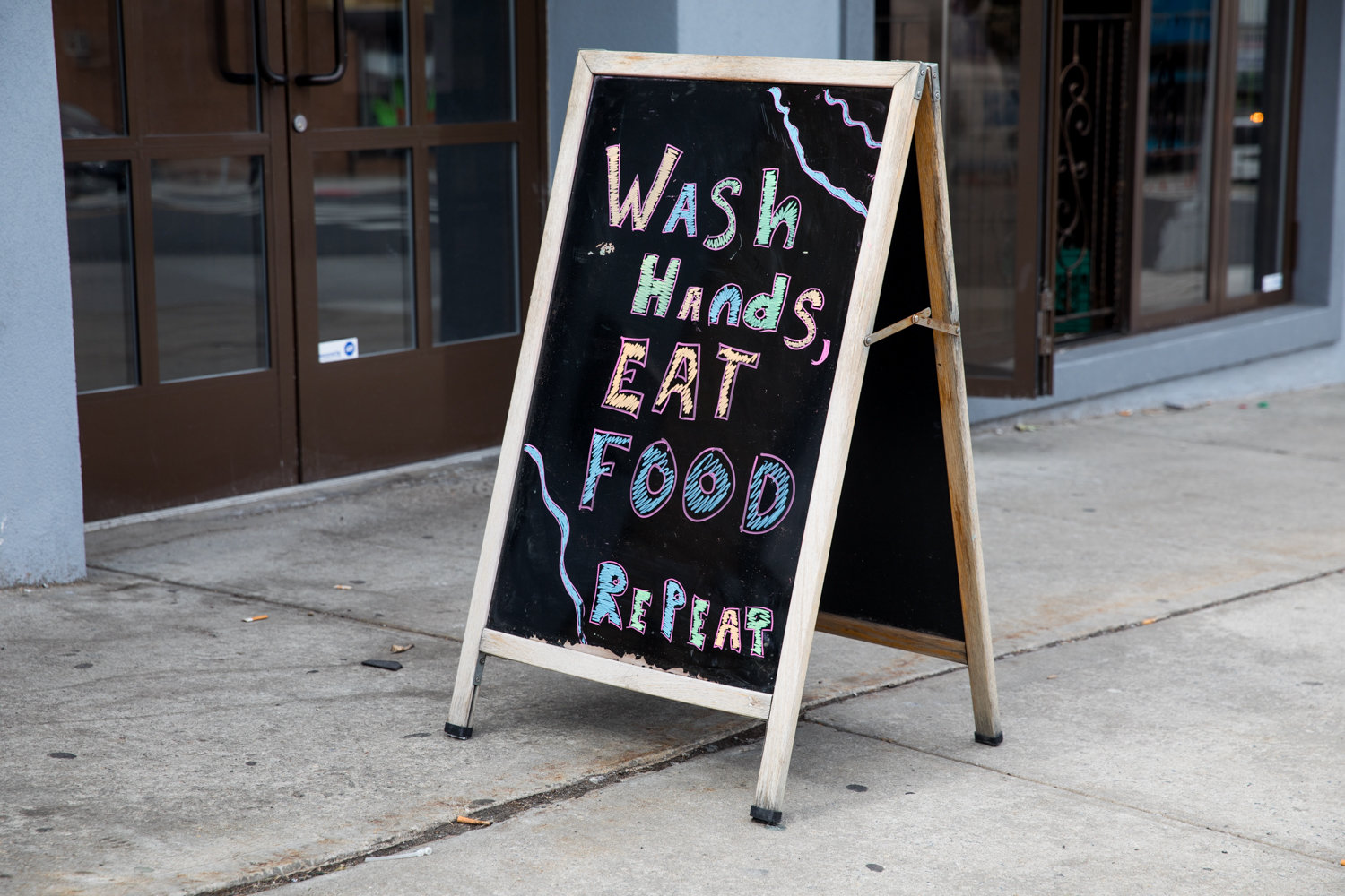 A sign outside of Ember by Smokey Joe on Riverdale Avenue urges people to wash their hands, echoing messaging by health professionals about preventative practices for the coronavirus. SAR Academy and SAR High School closed March 3 over a suspected case of the virus.